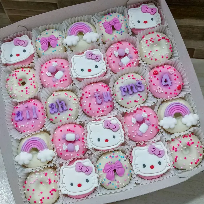 Themed mini donuts with kitty faces, rainbows and number toppers