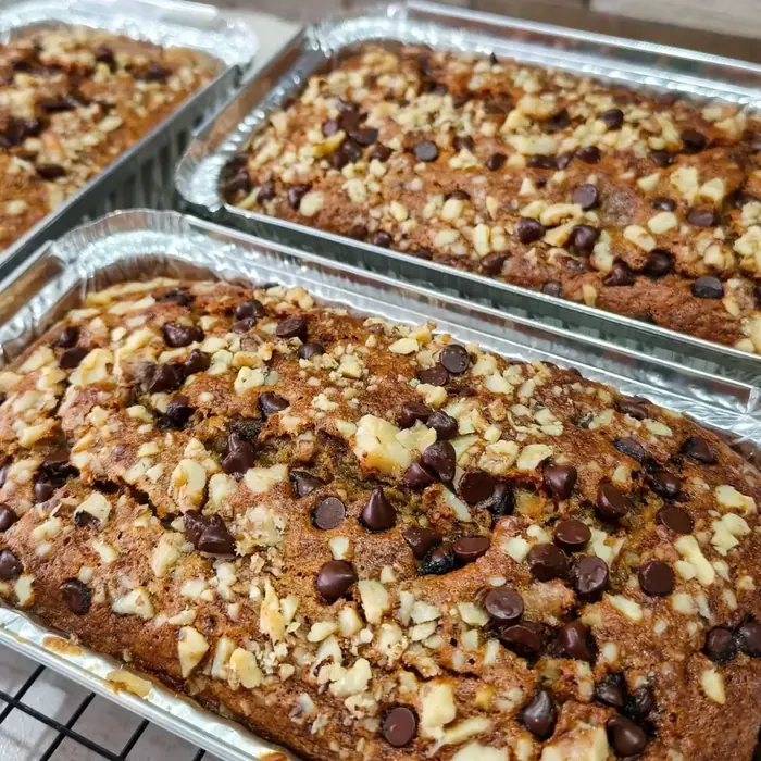 Banana loaves loaded with chocolate chips and nuts in foil pans